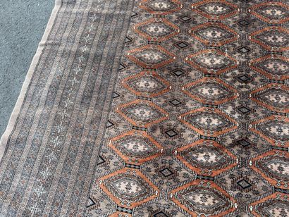 Large hand-knotted wool rug featuring stylized...