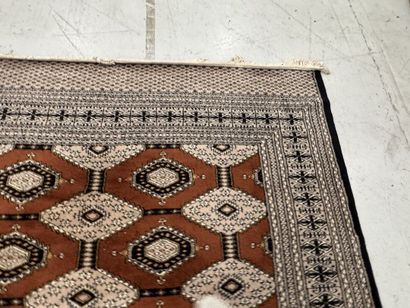 Large machine-woven wool rug featuring geometric...