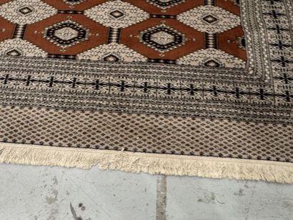Large machine-woven wool rug featuring geometric...