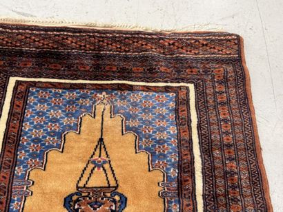 Small hand-knotted wool rug featuring a design...