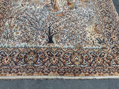A significant hand-knotted wool rug featuring...