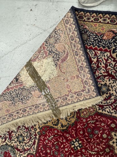 A significant hand-knotted wool rug featuring...