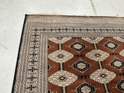 Large machine-woven wool rug featuring geometric...