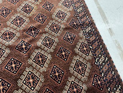 Hand-knotted wool rug featuring stylized...