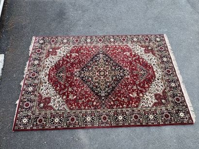 Machine-woven wool rug with a knotted design...