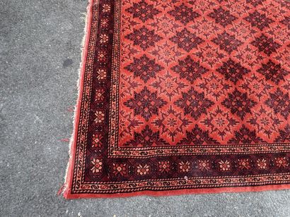 Hand-knotted wool rug with an orange background.
215...