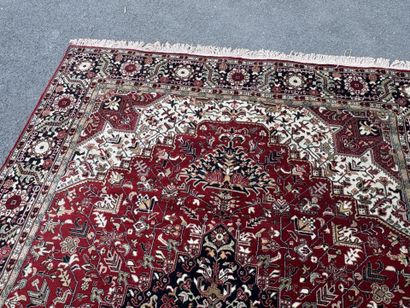 Machine-woven wool rug with a knotted design...