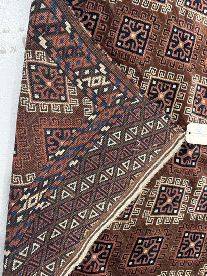 Hand-knotted wool rug featuring stylized...