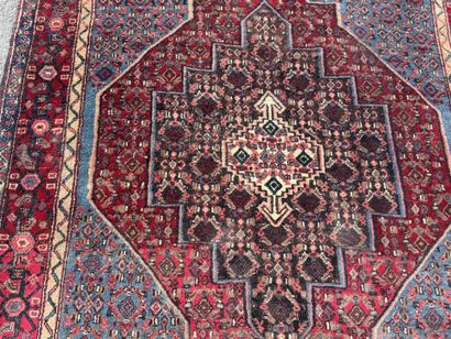Hand-knotted wool rug featuring stylized...