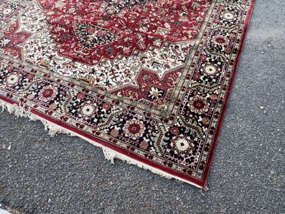 Machine-woven wool rug with a knotted design...