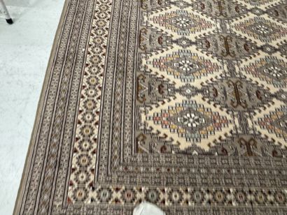 Large machine-woven wool rug featuring geometric...
