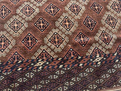 Hand-knotted wool rug featuring stylized...