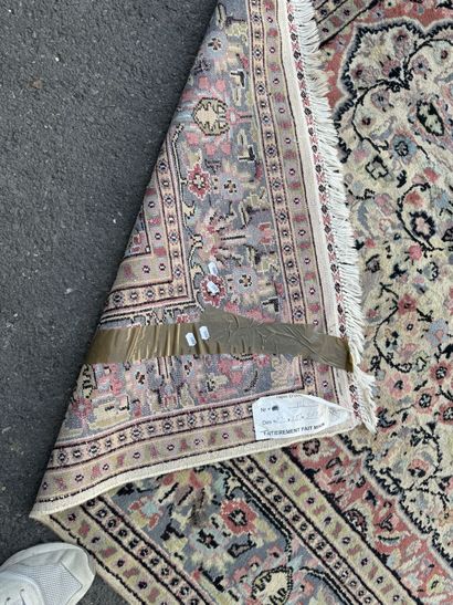 A large, hand-knotted wool rug featuring...