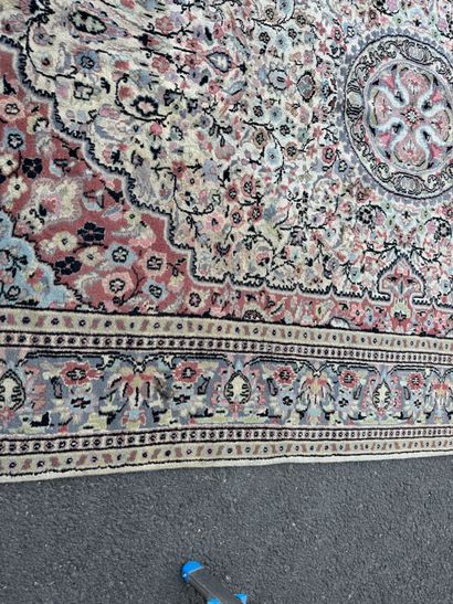 A large, hand-knotted wool rug featuring...