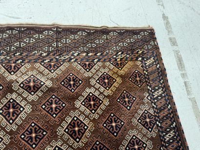 Hand-knotted wool rug featuring stylized...