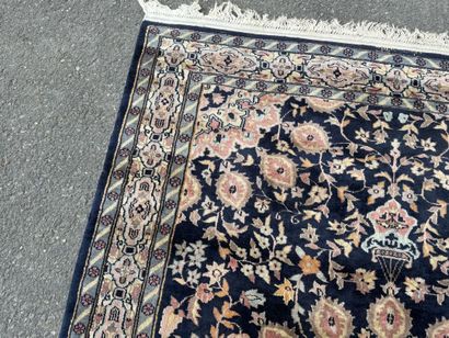 Hand-knotted wool rug featuring a foliage...