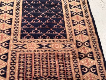 Small hand-knotted wool rug with stylized...