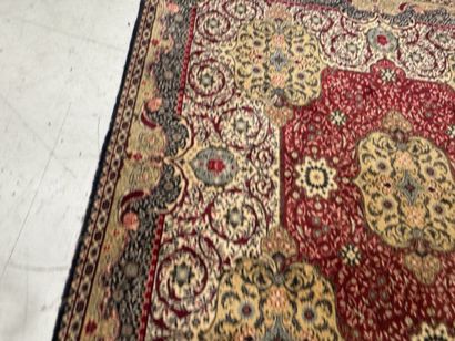 A significant hand-knotted wool rug featuring...