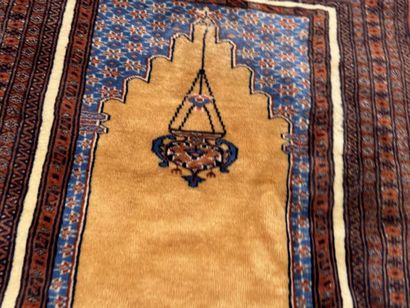 Small hand-knotted wool rug featuring a design...