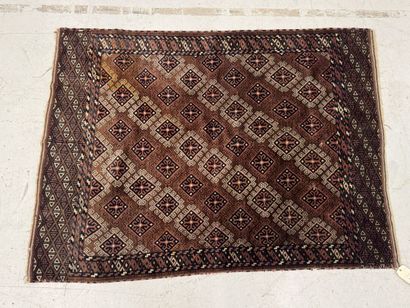 Hand-knotted wool rug featuring stylized...