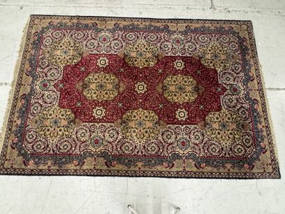 A significant hand-knotted wool rug featuring...