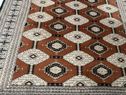 Large machine-woven wool rug featuring geometric...
