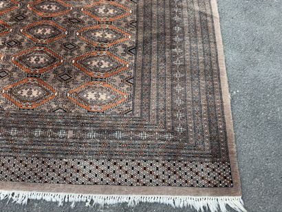 Large hand-knotted wool rug featuring stylized...