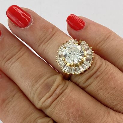 Gold ring with a round stone surrounded by...