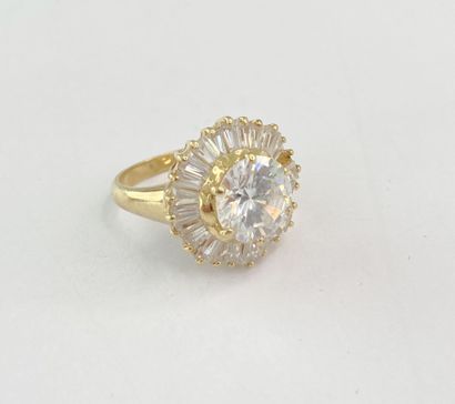 Gold ring with a round stone surrounded by...