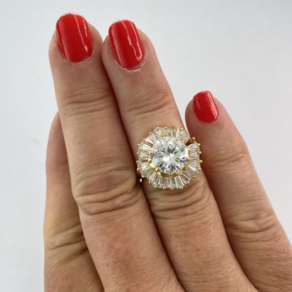Gold ring with a round stone surrounded by...