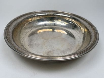 A circular, deep dish made of silver plated...