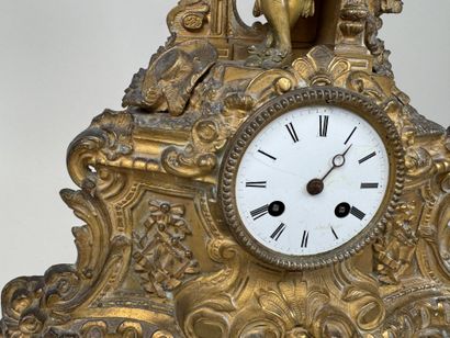 A pendulum clock with a golden patina, depicting...