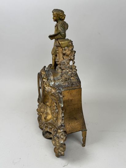 A pendulum clock with a golden patina, depicting...