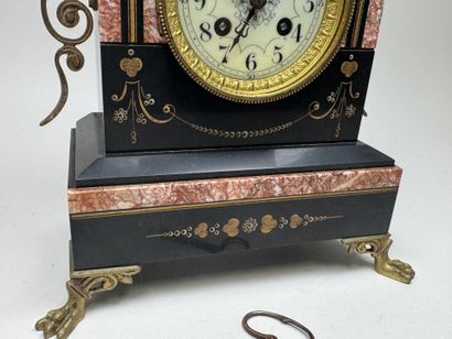 Black marble clock with a circular dial featuring...