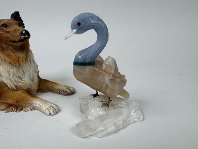 A hardstone swan resting on a piece of white...