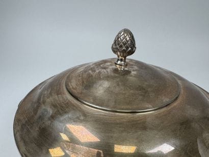 A large, silver plated metal-covered vegetable...