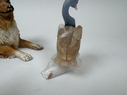 A hardstone swan resting on a piece of white...