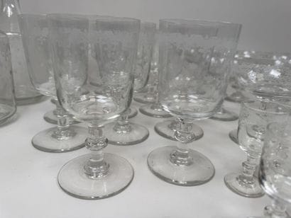 A set of glassware featuring engraved, stylized...