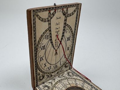 Small, fold-out pocket compass made of wood...