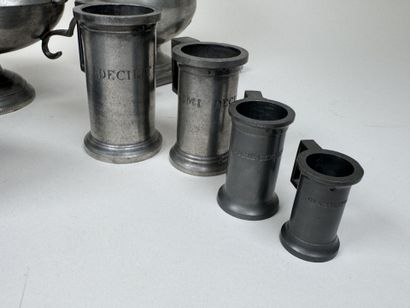 An 11-piece pewter set including a plate,...