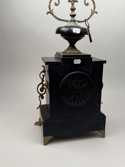 Black marble clock with a circular dial featuring...