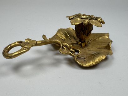 Handheld candlestick made of gilded bronze,...