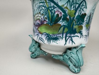 Large polychrome ceramic planter with a foliage...