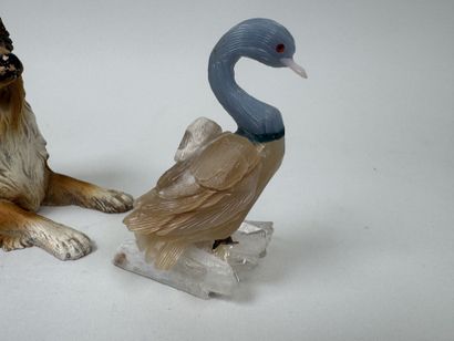A hardstone swan resting on a piece of white...