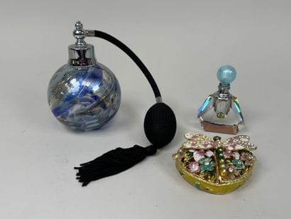 Colored glass perfume bottle and spray.
It...