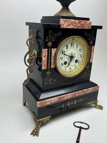 Black marble clock with a circular dial featuring...