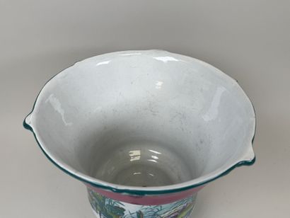 Large polychrome ceramic planter with a foliage...