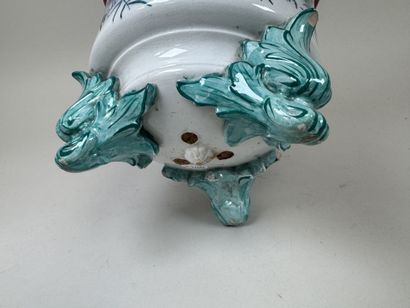 Large polychrome ceramic planter with a foliage...