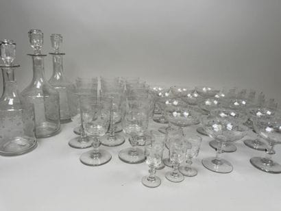 A set of glassware featuring engraved, stylized...