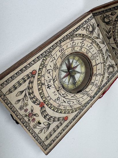 Small, fold-out pocket compass made of wood...